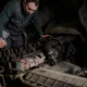 mechanic examining diesel engine 80x80