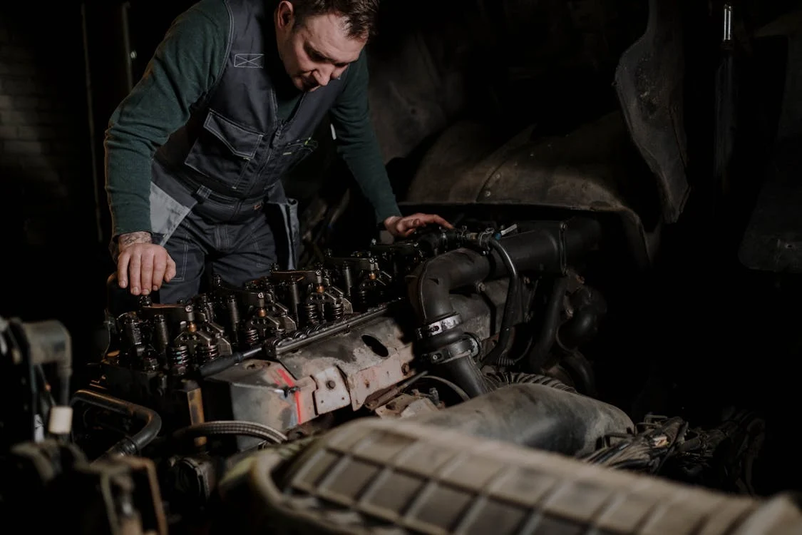 mechanic examining diesel engine