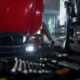 mechanic leaning under hood of diesel truck 1 80x80