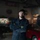 mechanic standing in garage with arms crossed 80x80