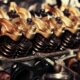 close up of the rocker arms valve springs and valve stems in an engine 80x80