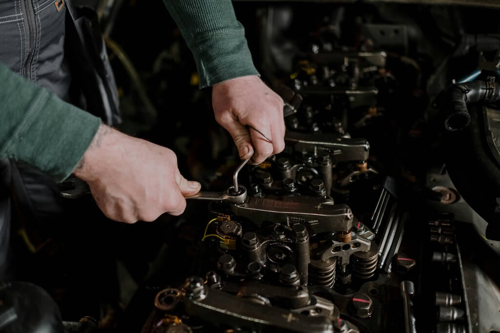 A person repairing an engine