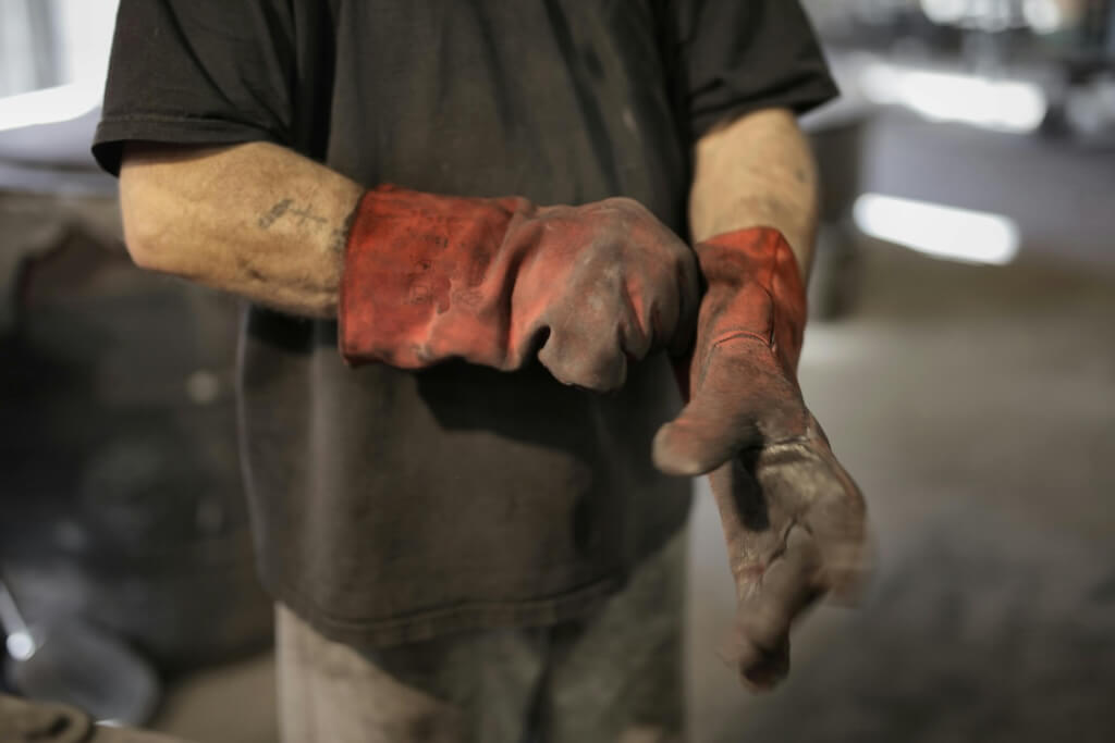 mechanic putting on gloves