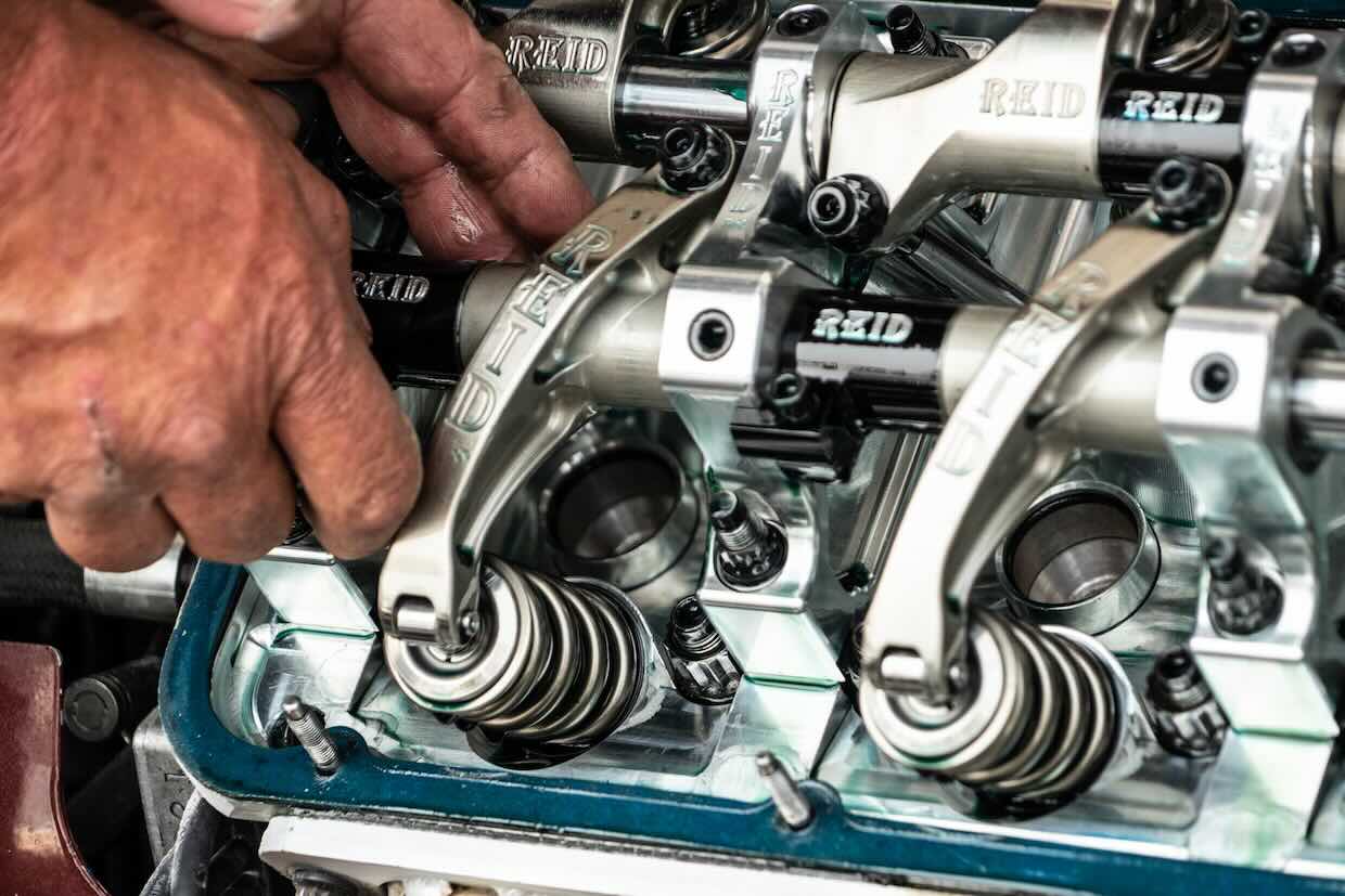 hands working on valvetrain assembly